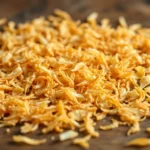 High-quality dehydrated toasted onion flakes in a jar, emphasizing their crispy texture and